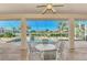 Covered patio has a dining table and chairs with a view of the pool and manicured backyard at 14405 Silver Lakes Cir, Port Charlotte, FL 33953