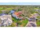 Aerial view of home with a red tile roof near a golf course and lake at 14429 Bridgeview Ln, Port Charlotte, FL 33953