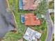 Beautiful aerial view of homes with red tile roofs, swimming pools and green lawns near a lake at 14429 Bridgeview Ln, Port Charlotte, FL 33953