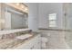 Bathroom featuring a large mirror, single sink with granite countertops, and tiled floors and walls at 14429 Bridgeview Ln, Port Charlotte, FL 33953