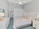 Bright bedroom with a ceiling fan, closet and white dresser with mirror at 14429 Bridgeview Ln, Port Charlotte, FL 33953