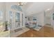 Bright entryway with decorative front door, hardwood and tile floors, and open view of the dining area at 14429 Bridgeview Ln, Port Charlotte, FL 33953