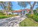 Beautiful single-story home with a tile roof, large driveway, and lush landscaping under a sunny sky at 14429 Bridgeview Ln, Port Charlotte, FL 33953