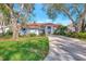 Inviting one-story home with an arched entry, a red tile roof, and a well-manicured lawn at 14429 Bridgeview Ln, Port Charlotte, FL 33953