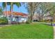 Charming one-story home with a red tile roof and lush green lawn at 14429 Bridgeview Ln, Port Charlotte, FL 33953