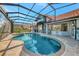 Beautiful enclosed in-ground pool with a connected spa and a gorgeous home at 14429 Bridgeview Ln, Port Charlotte, FL 33953