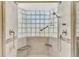 Close up of a tiled shower with dual shower heads and built in seats at 14429 Bridgeview Ln, Port Charlotte, FL 33953