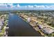 Aerial view of waterfront homes along canal, property outlined in red, with private dock at 15524 Ruston Cir, Port Charlotte, FL 33981