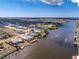 Aerial view of waterfront neighborhood featuring canal access, private docks, and boat lifts at 15524 Ruston Cir, Port Charlotte, FL 33981