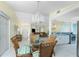 Elegant dining area features a stylish table setting and a view into the living room and kitchen at 15524 Ruston Cir, Port Charlotte, FL 33981