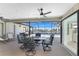 Outdoor dining on a screened patio with ceiling fan overlooking the waterway and pool at 15524 Ruston Cir, Port Charlotte, FL 33981