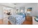 Bedroom with wooden floors, coastal bedding, lamps, and decor at 1586 Overbrook Rd, Englewood, FL 34223