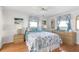 Cozy bedroom with coastal-themed bedding, lamps, and wooden furniture at 1586 Overbrook Rd, Englewood, FL 34223