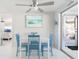 Dining area featuring white walls, white table with blue chairs, and coastal-themed decor at 1586 Overbrook Rd, Englewood, FL 34223