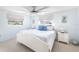 Coastal-themed main bedroom with white furniture, ceiling fan, and natural light at 1586 Overbrook Rd, Englewood, FL 34223