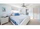 Coastal-themed main bedroom featuring white furniture, ceiling fan, and ensuite bathroom at 1586 Overbrook Rd, Englewood, FL 34223