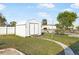 Storage shed with double doors and ramp in backyard with established lawn and landscaping at 1586 Overbrook Rd, Englewood, FL 34223