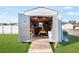 View of the open shed showing a lawn mower and storage at 1586 Overbrook Rd, Englewood, FL 34223