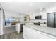 Well-lit kitchen with stainless steel appliances, a view into the living area, and modern cabinetry at 1591 Beach Rd # 403, Englewood, FL 34223