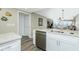 Kitchen featuring stainless steel dishwasher, granite countertop and white cabinets at 1591 Beach Rd # 403, Englewood, FL 34223