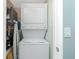 Efficient laundry area with stacked washer and dryer at 1591 Beach Rd # 403, Englewood, FL 34223