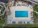 Aerial view of community pool with lounge chairs and tables at 1591 Beach Rd # 403, Englewood, FL 34223