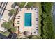 Aerial view of a rectangular pool with ample lounge chairs and tropical landscaping at 1591 Beach Rd # 403, Englewood, FL 34223