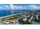 Stunning aerial view of the beach, condos, and neighborhood, with beautiful blue water, sky and puffy clouds at 1651 Beach Rd # 301, Englewood, FL 34223