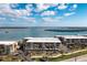 Stunning aerial view of waterfront condo community with beautiful bay views and lush landscaping at 1651 Beach Rd # 301, Englewood, FL 34223