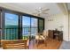 Balcony with sliding glass doors, a table and chairs, and unobstructed views of the water at 1651 Beach Rd # 301, Englewood, FL 34223