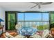 Balcony featuring a glass table and wicker chairs with stunning water views at 1651 Beach Rd # 301, Englewood, FL 34223