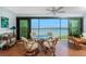 Balcony featuring a glass table and wicker chairs with stunning water views at 1651 Beach Rd # 301, Englewood, FL 34223