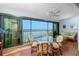 Balcony featuring a glass table and wicker chairs and views of the waterway at 1651 Beach Rd # 301, Englewood, FL 34223