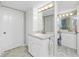 Bathroom featuring dual sinks, vanity with storage and views into the tiled walk-in shower at 1651 Beach Rd # 301, Englewood, FL 34223