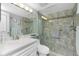 Bathroom showcasing a tiled shower, a sink, and vanity with modern fixtures at 1651 Beach Rd # 301, Englewood, FL 34223