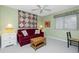 Bright bedroom with a cozy sofa, complementary end tables, and tranquil decor at 1651 Beach Rd # 301, Englewood, FL 34223