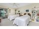 Bedroom features two twin beds, closet, and view to the Lanai at 1651 Beach Rd # 301, Englewood, FL 34223