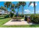 Outdoor picnic area with a grill and umbrella providing a perfect spot for gatherings at 1651 Beach Rd # 301, Englewood, FL 34223