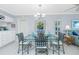 Dining area features modern table with blue accents and natural light at 1651 Beach Rd # 301, Englewood, FL 34223