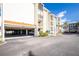 Exterior angle showing condo parking, multiple stories and exterior paint detail at 1651 Beach Rd # 301, Englewood, FL 34223