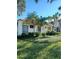 Beautifully landscaped building with lush tropical foliage and a well-maintained lawn at 1651 Beach Rd # 301, Englewood, FL 34223