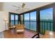 Relaxing lanai with ocean views, tile floor, and table with chairs at 1651 Beach Rd # 301, Englewood, FL 34223