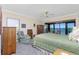 Well-lit main bedroom featuring an outside balcony with water views and a ceiling fan at 1651 Beach Rd # 301, Englewood, FL 34223