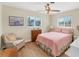 Cozy bedroom with a hardwood floor, chair, bed, and chest of drawers at 1710 Loralin Dr, Englewood, FL 34223