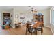 Dining room showcases wood flooring, a china cabinet, and a partial view of the kitchen at 1710 Loralin Dr, Englewood, FL 34223