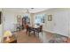 Bright dining room features a wooden table, ceiling fan, and window with natural light at 1710 Loralin Dr, Englewood, FL 34223