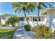 Inviting single-story home featuring a well-manicured yard, decorative rocks, and mature landscaping at 1710 Loralin Dr, Englewood, FL 34223