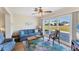 Living room with sliding glass doors to the yard and an accent rug over hardwood flooring at 1710 Loralin Dr, Englewood, FL 34223