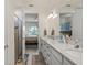 This bathroom features a double sink vanity and doorway leading to the bedroom at 17728 Silverspur Dr, Punta Gorda, FL 33982