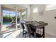 Dining area with table for four and sliding glass doors leading to outdoor living area and pool at 17728 Silverspur Dr, Punta Gorda, FL 33982